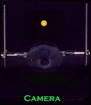 Demonstration setup for gravitational microlensing.